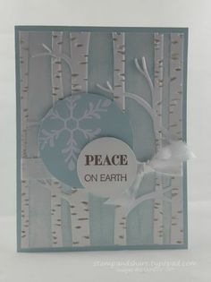 a card with trees and snowflakes on it, saying peace on each side