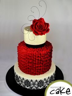 a red and white cake with a rose on top is shown in front of a sign that says cake