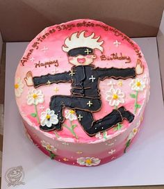 a pink birthday cake decorated with an image of a man