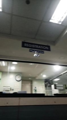 there is a sign that says registration on the wall above the counter in this building