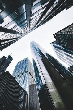 looking up at tall skyscrapers from the ground