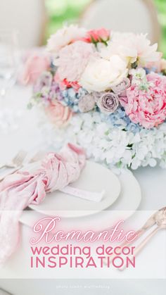 the table is set with pink and white flowers, silverware, and napkins