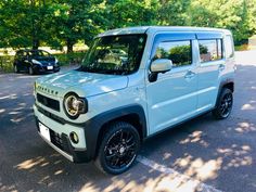 a light blue jeep parked in a parking lot