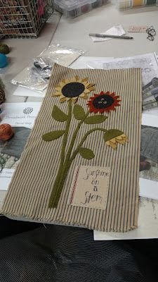 a table topped with lots of crafting supplies and flowers on top of paper towels