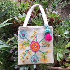 New With Tag Beauty And Artistic Charm Abound In This Thick, Wool Tote By Jenny Krauss With Cheerful, Floral Crewelwork And Removable Pom Pom Detail. Lined, Magnetic Closure, Two Inside Slot Pockets. Imported. Exclusive. Approx. 12"W X 1"D X 13"H. Bundle Up And Save Even More Fast Shipping Small Handmade Bag For Daily Use, Natural Embroidered Tote Bag, Natural Color Embroidered Tote Bag, Small Handmade Bags For Daily Use, Spring Embroidered Beach Bag, Small Bags With Detachable Handle For Everyday Use, Small Everyday Bag With Detachable Handle, Small Bag With Detachable Handle For Everyday Use, Handmade Spring Pouch Bag