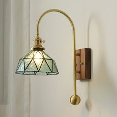 a wall light with a stained glass shade