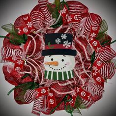 a christmas wreath with a snowman on it