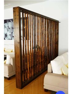 a living room with white couches and wooden slats