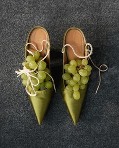 a pair of green shoes with grapes tied to them