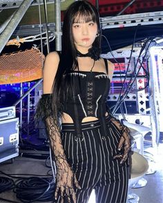 a woman with long black hair wearing a corset