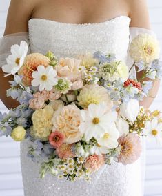 a bride holding a bouquet of flowers in her hands