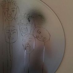 a mirror that has some drawings on it