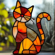 a stained glass cat sitting on top of a table