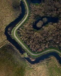 an aerial view of a winding road in the countryside