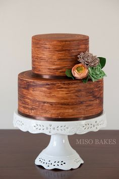 a three tiered cake with flowers on top