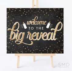 a black and gold sign with the words welcome to the big reveal written on it