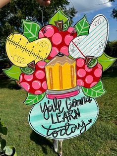 a hand holding up a sign with an image of a jar full of food and writing on it