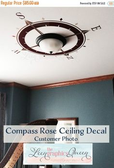 the compass rose ceiling decal is hanging from the ceiling in a room with blue walls