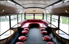 the inside of an old school bus with red seats