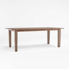 a wooden table sitting on top of a white floor