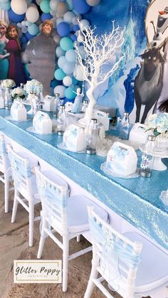 there is a table set up for a frozen princess birthday party with balloons and decorations