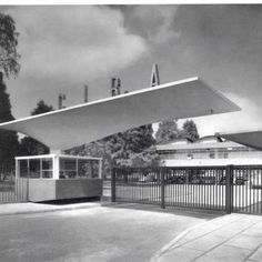 black and white photograph of the front entrance to an art museum with a large metal structure above it