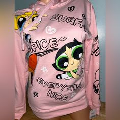 a female mannequin wearing a pink sweatshirt with cartoon characters on it