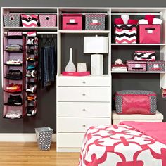 an organized closet with pink and white storage bins, drawers, and other items