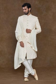 Cream sherwani featuring sequin and bead hand work in geometric, floral pattern. Paired with a churidar and an embellished hem dupatta. - Aza Fashions Bollywood Art Silk Sherwani With Chikankari Embroidery, Festive Designer Sherwani With Chikankari Embroidery, Bandhgala With Resham Embroidery For Reception Navratri, Resham Embroidered Bandhgala For Reception Navratri, White Semi-stitched Sherwani With Mirror Work, Designer Art Silk Sherwani With Chikankari Embroidery, Traditional Bandhgala With Chikankari Embroidery In Art Silk, Elegant Bandhgala With Chikankari Embroidery For Navratri, Festive Semi-stitched Sherwani With Mirror Work