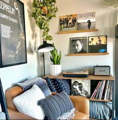 a living room filled with lots of furniture and pictures on the wall next to a lamp