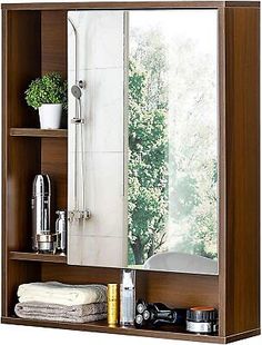 a bathroom with a mirror, sink and shelves on it's sides in front of a window