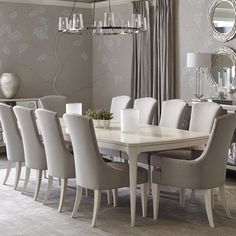 a dining room table with chairs and a chandelier