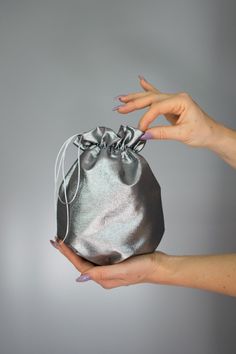 Elegant satin bag / money bag / purse ! Ideal for your wedding day, night out, party ,special occasion Made of beautiful silver grey bridal taffeta fabric. You can change colors Fabric : taffeta Lining : poliester Size : approx. 18 cm x 18 cm Silver Evening Bag With Dust Bag For Party, Elegant Metallic Bag For Gift, Elegant Metallic Bag As Gift, Elegant Metallic Bags For Gifts, Silver Pouch Evening Bag As Gift, Elegant Gray Bag For Gift, Silver Clutch Evening Bag As A Gift, Silver Clutch Evening Bag Perfect As A Gift, Silver Pouch Bag For Gift