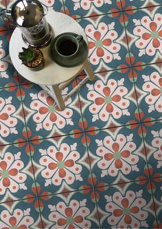 a table with a potted plant on it and a cup of coffee next to it