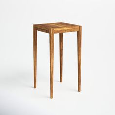 a small wooden table sitting on top of a white floor