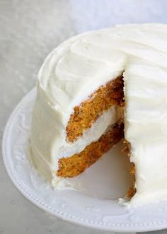 a carrot cake with white frosting on a plate