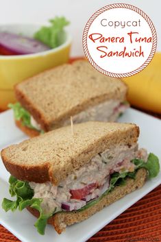 there is a sandwich on a plate with lettuce and tomato in the background