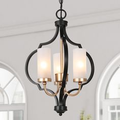 a chandelier with three lights hanging from it