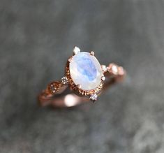 a close up of a ring with a rainbow stone