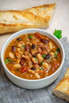 a white bowl filled with beans and bread