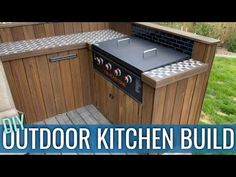 an outdoor kitchen built into the side of a wooden building with text overlay that reads diy outdoor kitchen build