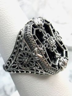 Black Camphor Glass Ring with Full Set  Stained Glass Design#203 Custom Made This is a lovely detailed and intricate Art Deco ring. This is lovely filigree reproduction in solid sterling silver. The sleek black glass is 18mm x 13mm. The sterling silver filigree gives the impression of a stained glass window.  There is a 1mm sparkle of CZ (cubic zirconia) in the center of the filigree. The ring is 21mm North to South and 16mm East to West on the finger. The inside of the band is etched 925 for st Intricate Art, Stock Design, Antique Filigree, Filigree Jewelry, Glass Ring, Sterling Silver Filigree, Silver Art, Glass Rings, Deco Jewelry