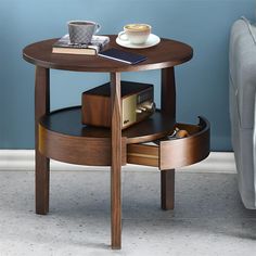 a coffee table with an open drawer on the bottom and a cup sitting on top