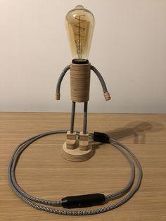 a light bulb is plugged into a cord connected to a lamp on a table