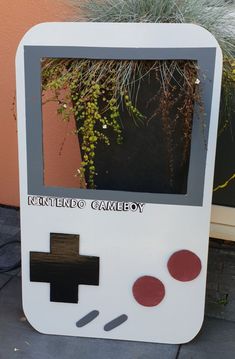 an old nintendo gameboy made to look like it's been built into a planter