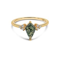 a gold ring with a green tourmaline and white diamonds on the side, set in