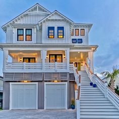 a two story house with white siding and stairs