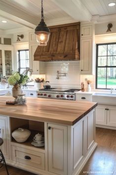 a large kitchen with an island in the middle and lots of cabinets on both sides