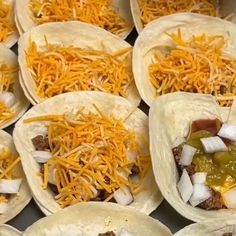 there are many tacos with cheese on them