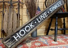 a baseball bat sitting on top of a rug next to a wooden chair and wall